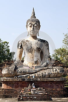 Sitting Buddha against Blue Sky