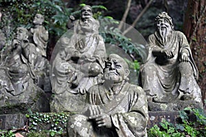 The Sitting Buddha between hundreds of Buddha statues of Japanese style.