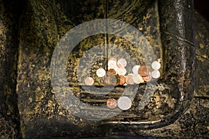 Sitting buddha statue with a merit coin money on the buddha`s hand at the buddhist temple.buddhism in thai donate their money for