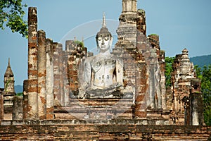 Sitting Buddha statue at the ruins of the main chapel of the Wat Mahathat temple in Sukhothai Historical Park, Thailand.