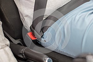 Sitting on car seat and fastening seat belt