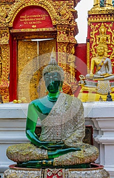 Sitting Emerald Buddha golden statue in thai Doi Suthep temple