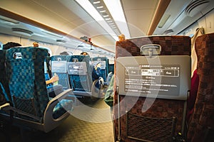 Sitting inside a modern train, Shinkansen, traveling along railway