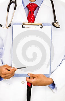 Sitting male doctor holding a blank clipboard