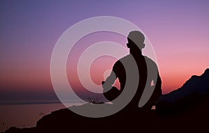 Sitting man silhouette in meditation pose