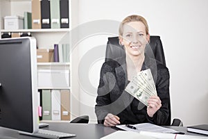 Sitting Manageress Showing US Dollar Paper Bills