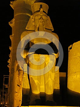 Sitting Ramesses II colossus inside Luxor Temple at night. Luxor, Egypt