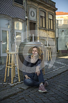 an sitting on the sidewalk at an outdoor cafe on the waterfront.