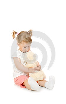 Sitting small girl with toy bear