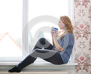 Sitting on windowsill with a cup of tea