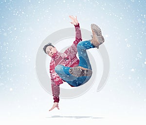 Situation, the man in a red sweater with a scarf is falling, around the snow. Concept of an accident