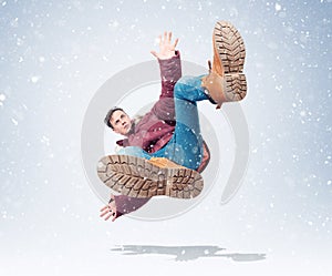 Situation, the man in red winter clothes is falling, around the snow. Concept of an accident