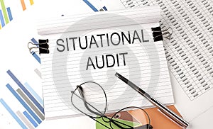 SITUATIONAL AUDIT text on the chart , office supplies, business concept