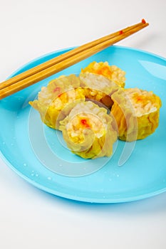 Siu Mai - Chinese steamed pork dumplings on blue plate