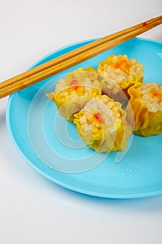 Siu Mai - Chinese steamed pork dumplings on blue plate