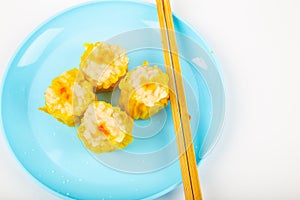 Siu Mai - Chinese steamed pork dumplings on blue plate