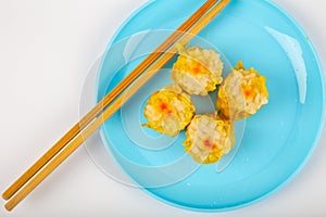 Siu Mai - Chinese steamed pork dumplings on blue plate