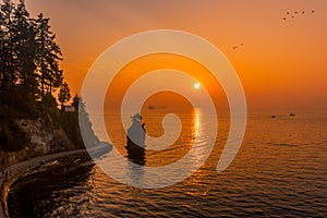 Siwash Rock and sea wall with red sunset sky backgrounds