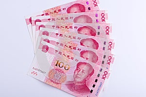 Six Chinese 100 RMB notes arranged as fan isolated on white back