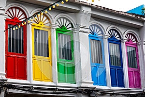 Six colorful doors or windows outside on the facade of an ancient house