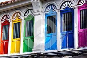 Six colorful doors or windows outside on the facade of an ancient house