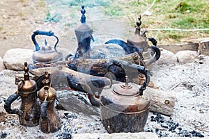 Six copper kettles on the stake