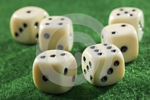 Six dices on a green table
