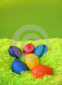 Six easter eggs on green