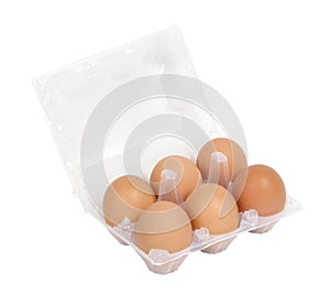 Six fresh eggs in a clear plastic tray
