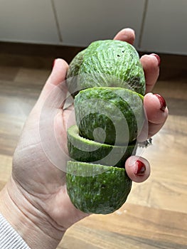 A woman's had holding feijoa skins photo