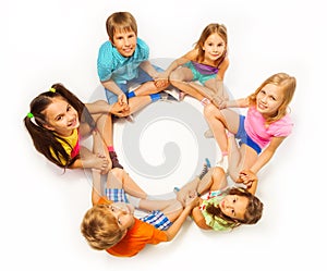 Six kids sit in a lotus pose