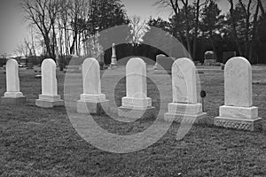 Six Matching Tombstones in Cemetary photo