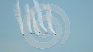 Six military fighter jets flying in the sky and performing a show - releasing out the smoke