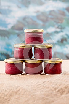 Six misted jam jars with berries