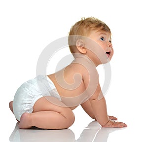 Six month infant child baby toddler sitting in diaper looking at