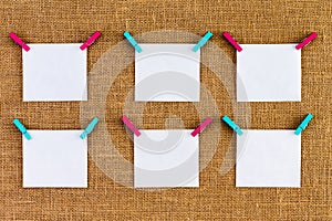 Six neatly aligned blank white notepads