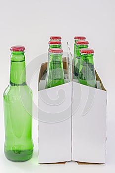 A six pack of a green beer bottles isolated on white background