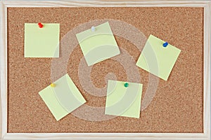 Six post-it notes with pins sticked on corkboard