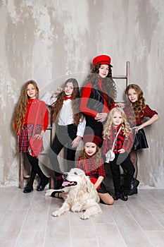 Six pretty girls of different ages, six sisters are posing indoors during repairs