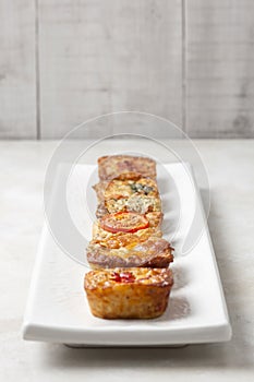 Six quiches on a white plate