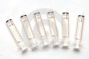 Six same sized syringes dispensers photo