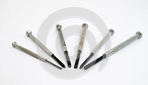 Six screwdrivers rigged in some form on a white background