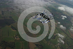 Six skydivers building a formation