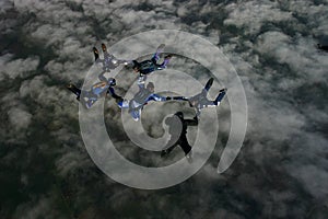 Six skydivers building a formation