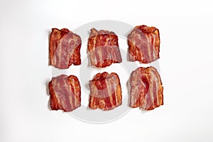 Six slices of fresh fried bacon lined up in a row photo
