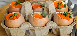 Six steam eggs decorate with orange ebiko and green slice spring onion in panel paper in restaurant. asian delicious cooking food.