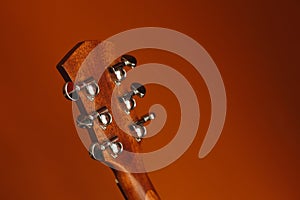 six-string acoustic guitar on a red background