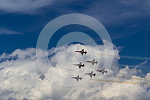 six Swiss army planes against a blue sky