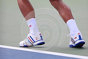 Six times Grand Slam champion Novak Djokovic wears custom Adidas tennis shoes during match at US Open 2014