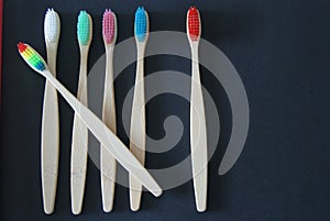 Six toothbrush different colors on black backgroound